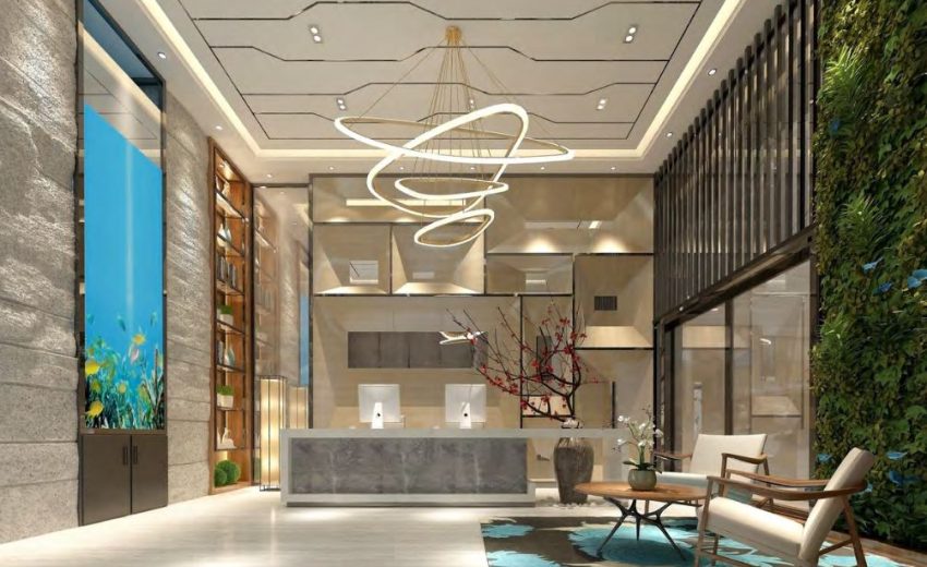 Interior view of a modern lobby featuring a reception desk, seating area, and decorative elements.