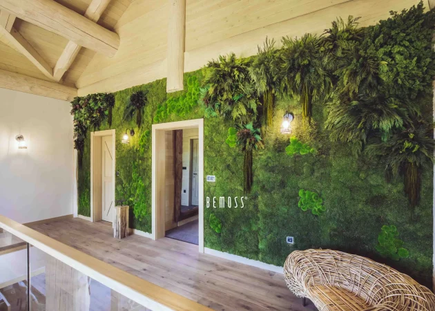 Interior wall featuring a lush green moss decoration with wooden accents and lighting.