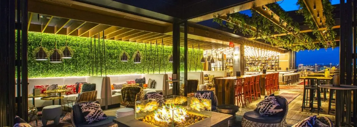 Interior view of Lincoln Social rooftop lounge featuring seating and a fire pit.