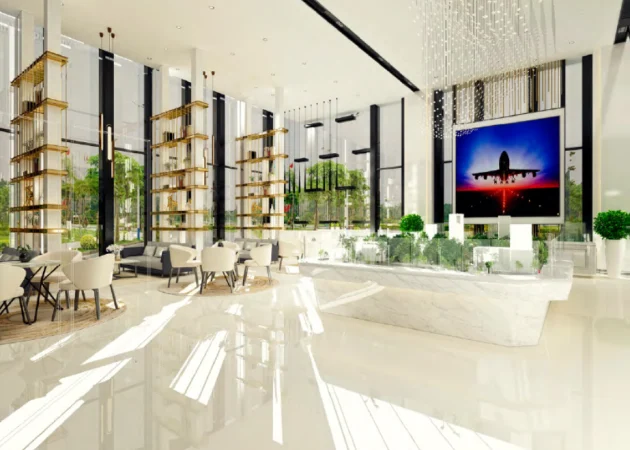 Interior view of a modern lobby featuring large windows, seating areas, and decorative plants.