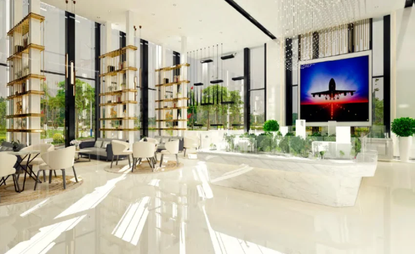 Interior view of a modern lobby featuring large windows, seating areas, and decorative plants.