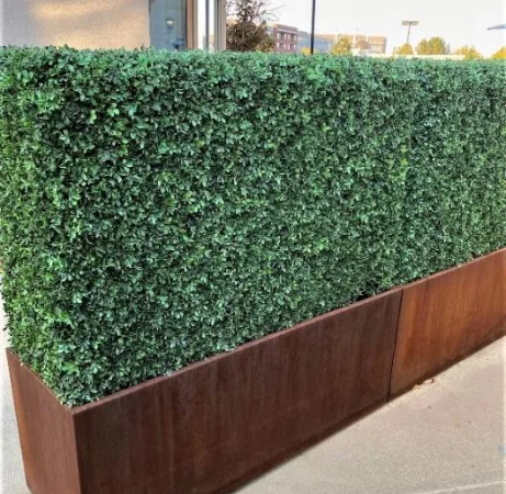 Custom faux boxwood hedge in a rectangular planter with a metal base.