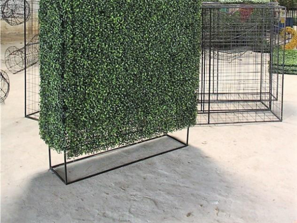 Custom faux boxwood hedge on a metal frame in a neutral setting.