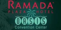 Ramada Plaza Hotel Oasis Convention Center sign featuring palm tree graphics and vibrant text for branding.