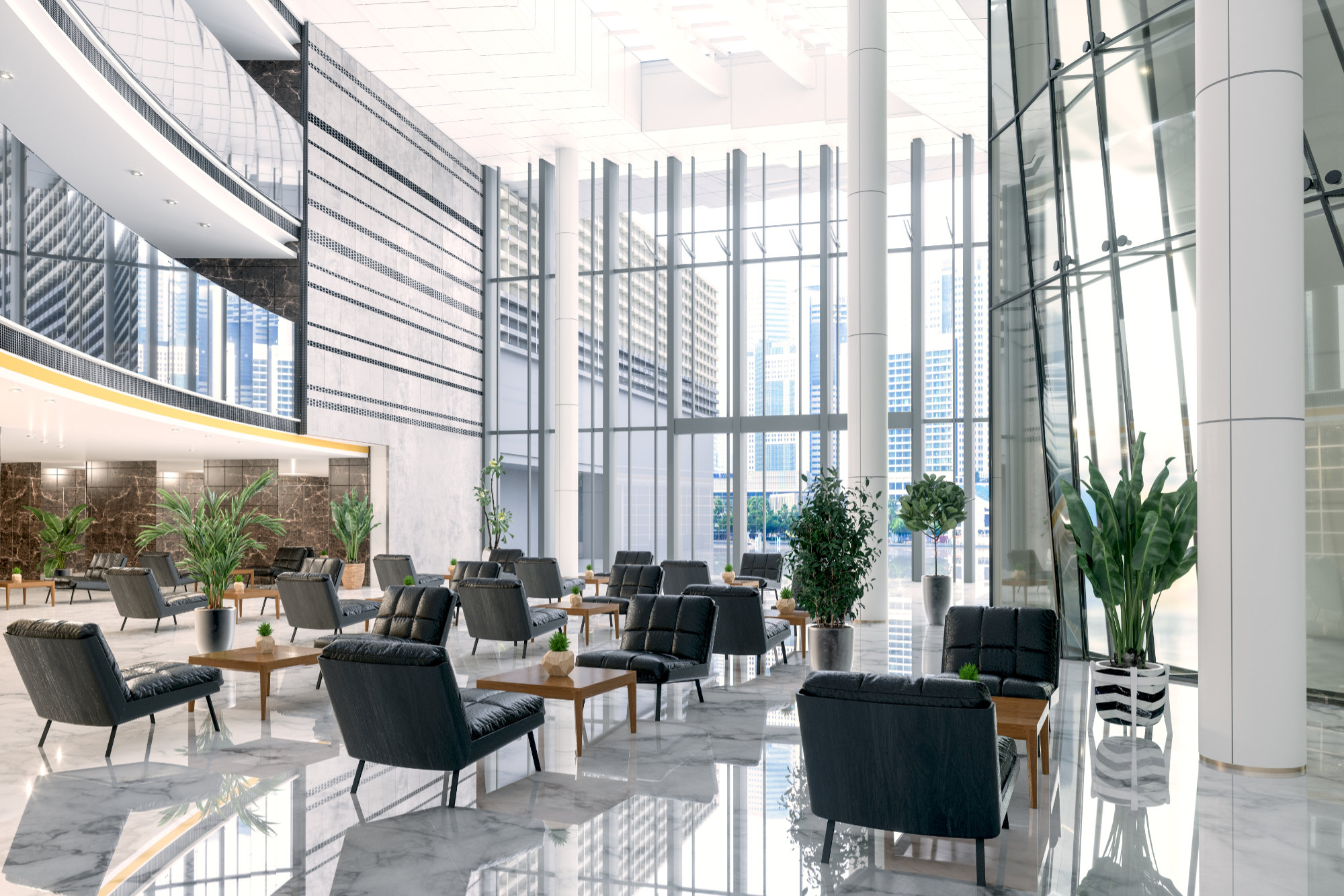 Bright modern lobby lounge with black armchairs, marble floors, and lifelike replica floral plants placed throughout a tall glass atrium.