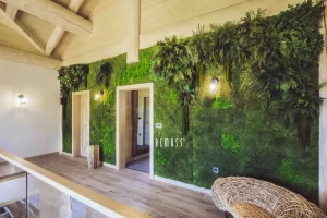 Interior wall featuring a lush green moss decoration with wooden accents and lighting.