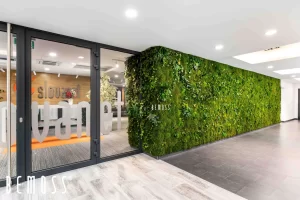 Indoor green wall featuring various plants and the brand name 'BEMOSS' displayed prominently.