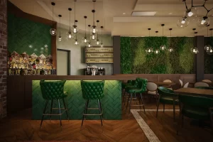 Interior view of a bar featuring a green wall and seating area with green chairs.