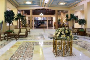 Hall,In,Hotel,With,Marble,Floor,And,Flowers,On,The